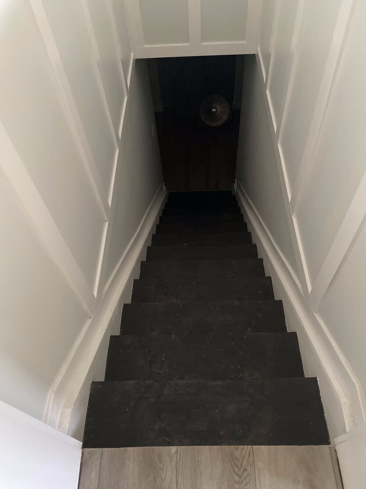 Refinished stairs with dark treads and white risers — JFK Surfaces flooring work in Central Alberta