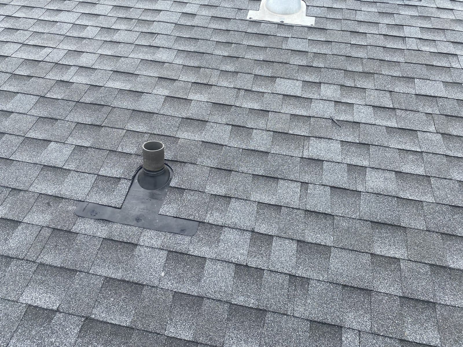 Plumbing boot & shingle patch detail — JFK Surfaces project in Central Alberta