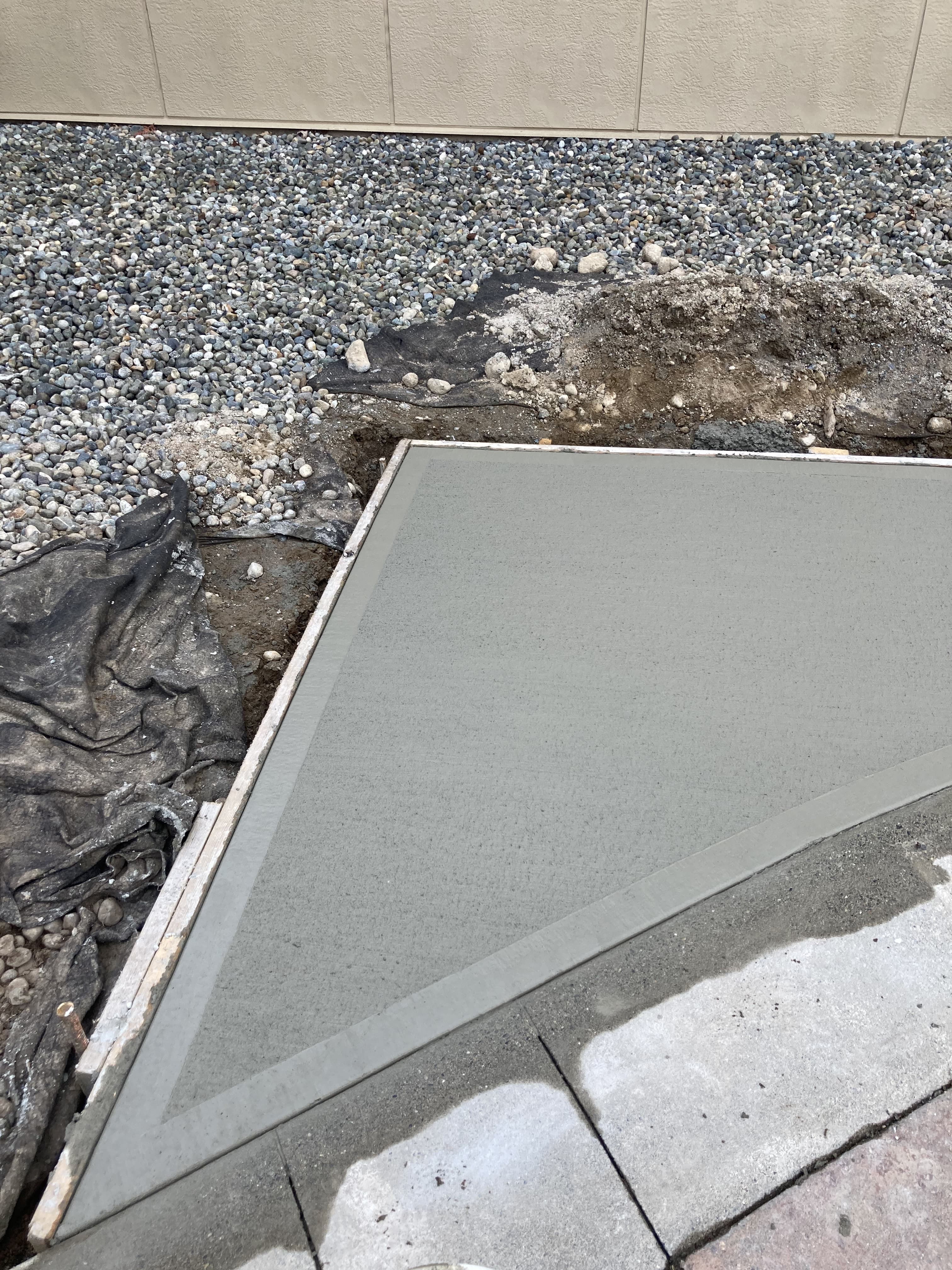 Freshly poured concrete flatwork walkway by JFK Surfaces in Central Alberta