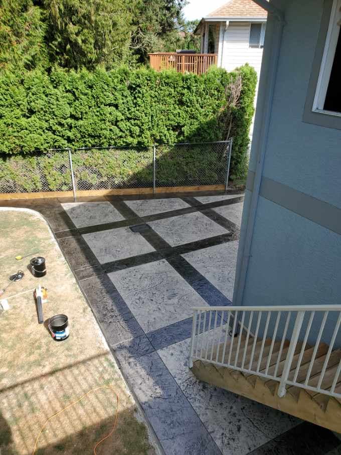 Large-format stamped concrete patio finished by JFK Surfaces in Central Alberta