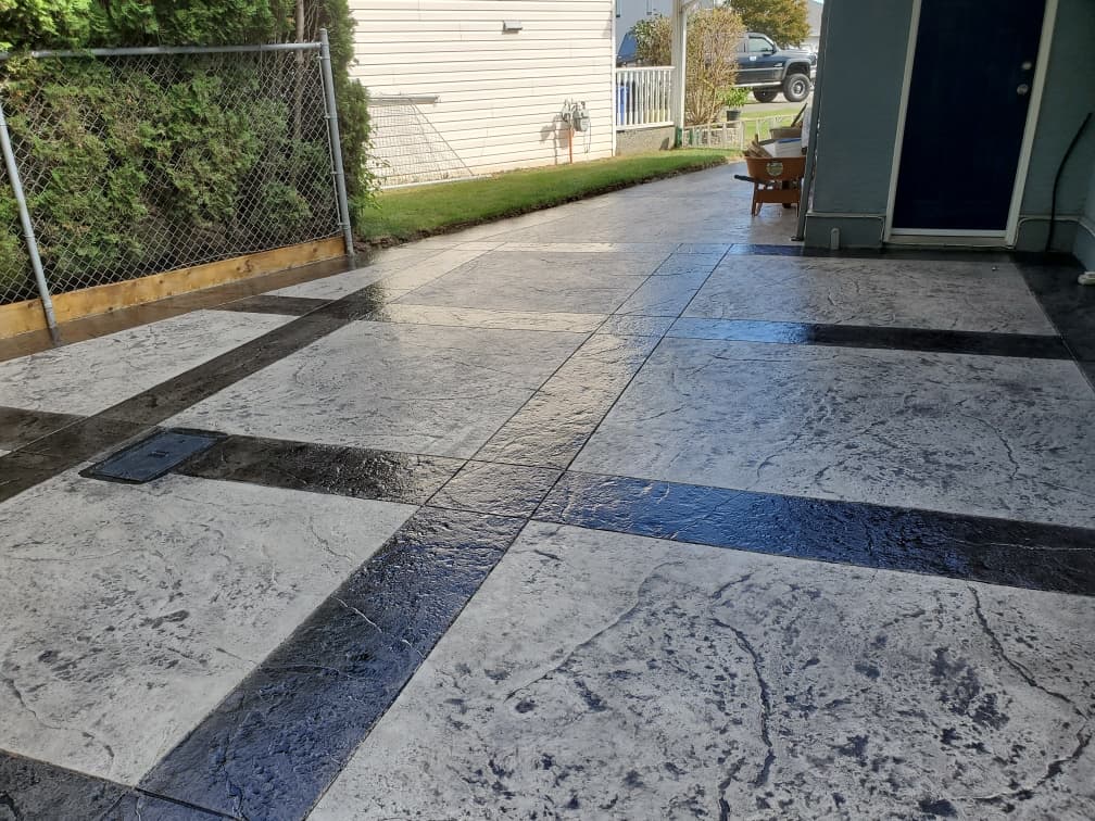Large-format stamped concrete patio poured by JFK Surfaces in Central Alberta